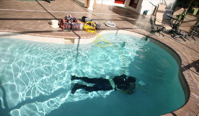 ALD technician searching for leak inside of pool